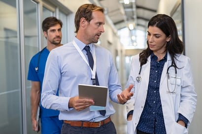 three hospital employees talk while walking